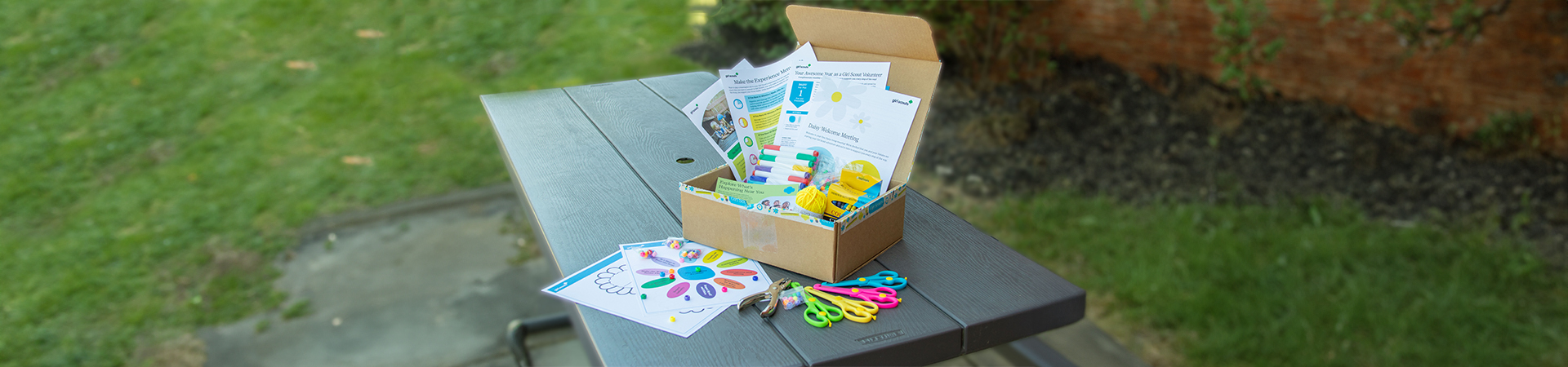  The experience box open on a picnic table, displaying the contents 