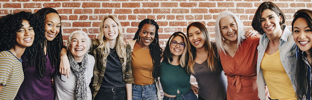  group of young girl scout alums smiling and talking to one another 