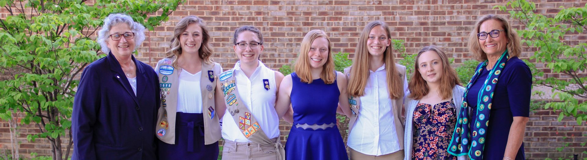  high school gold award girl scouts at ceremony with CEO & COO 